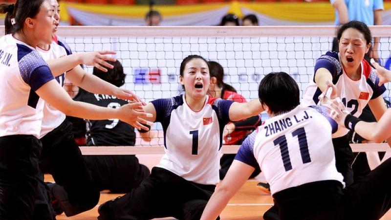 Chinese female sitting volleyball players celebrate a point