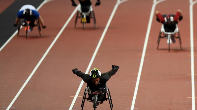 A wheelchair racer ahead of three competitors