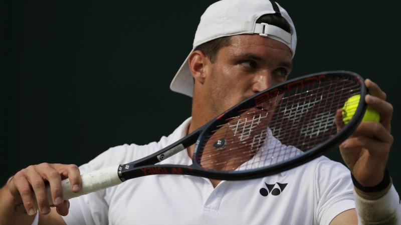 Close shot on Argentinian wheelchair tennis player Gustavo Fernandez about to serve