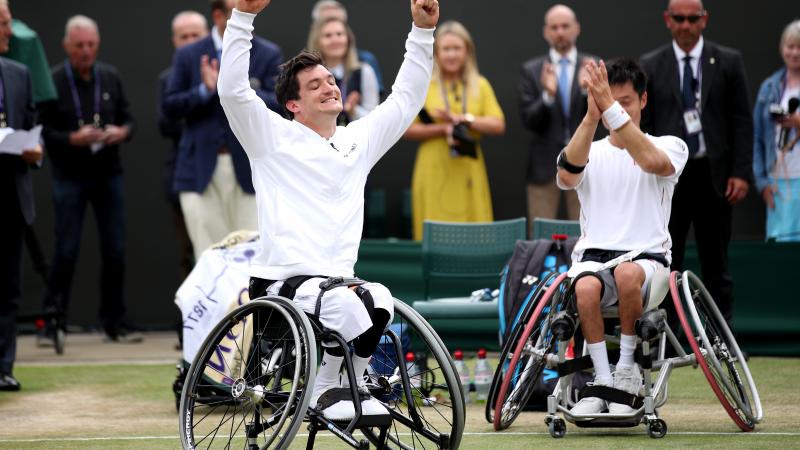 Gustavo Fernandez celebrates with his hands up while Shingo Kunieda claps in the background