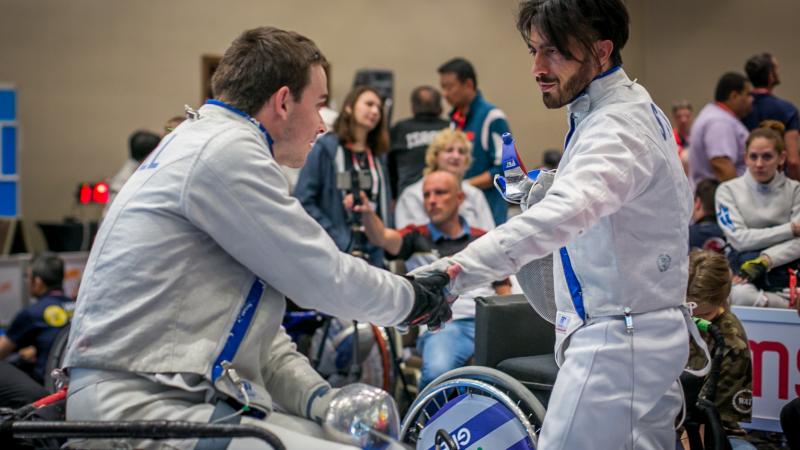 Iraq refugee Wissam Sami greets Canada's Ryan Roussel during the IWAS Wheelchair Fencing World Cup in Warsaw, Poland