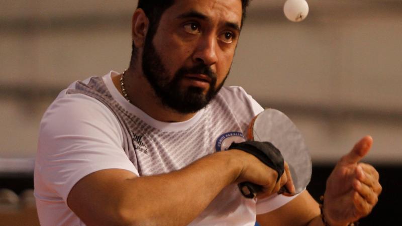 Chilean table tennis player Luis Flores serving