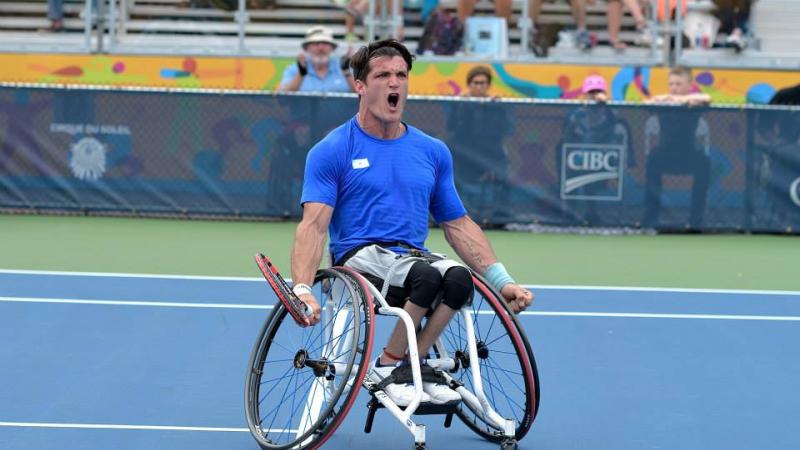 Argentinian wheelchair tennis player Gustavo Fernandez screams with joy on the court after winning gold at Toronto 2015