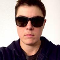 A picture of a white person with short hair and sunglasses