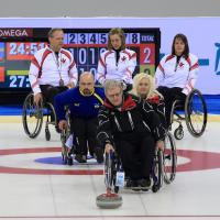 A picture of person in wheelchairs playing curling