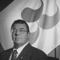 Robert D Steadward in front of old IPC flag