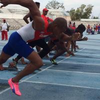 a group of Para sprinters spring from the blocks