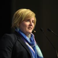 A woman speaks at a podium