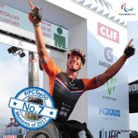 a male Para triathlete crosses the finish line