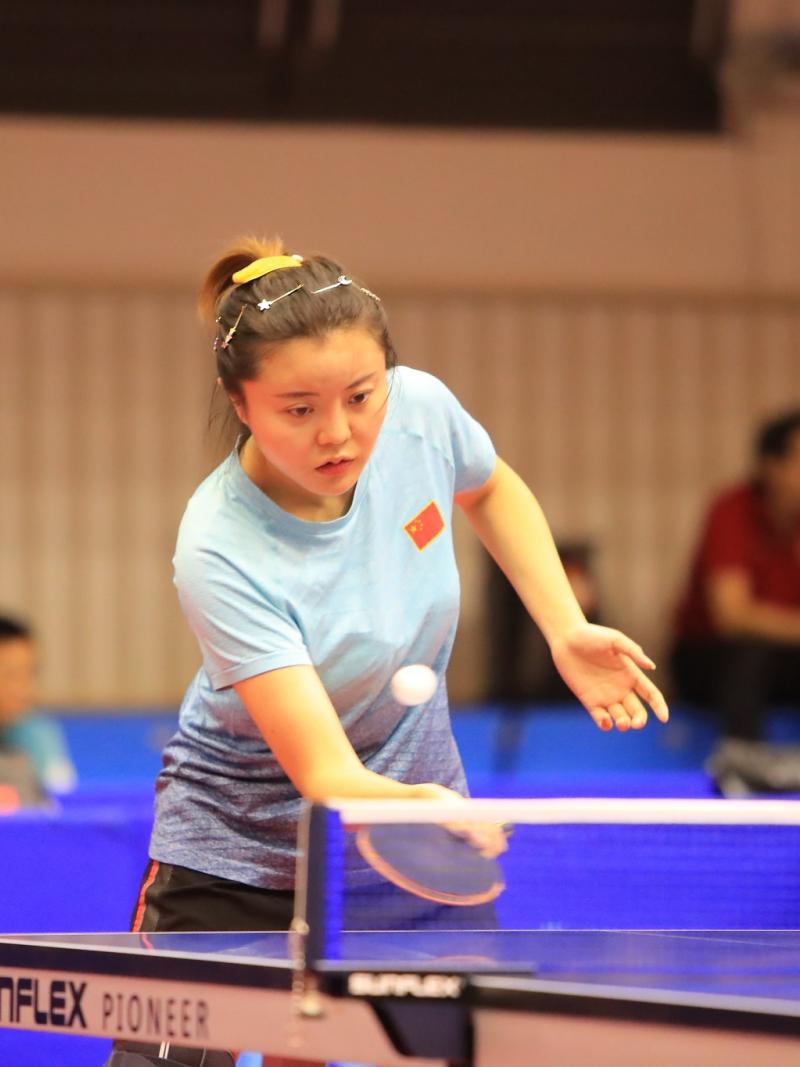 Chinese female table tennis player hits a return ball