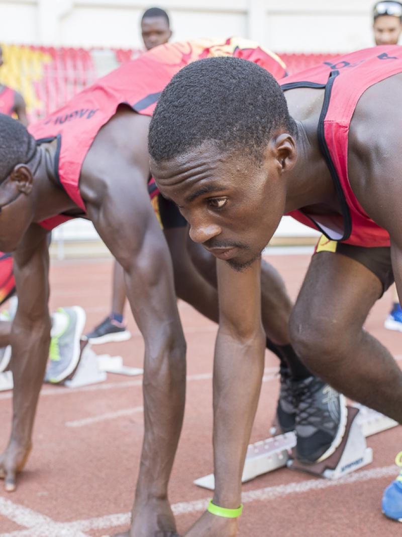 Athletes and guides prepare in starting blocks during Agitos Foundation training camp in Luanda