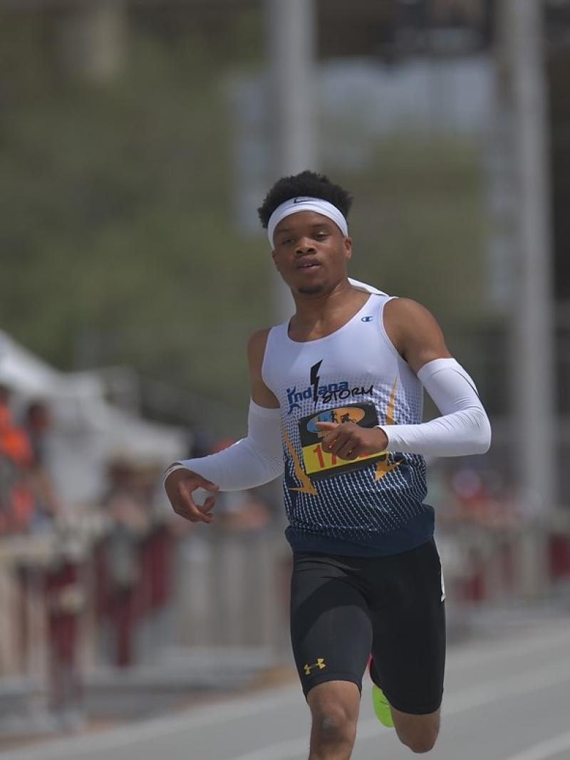 A man running on an athletics track