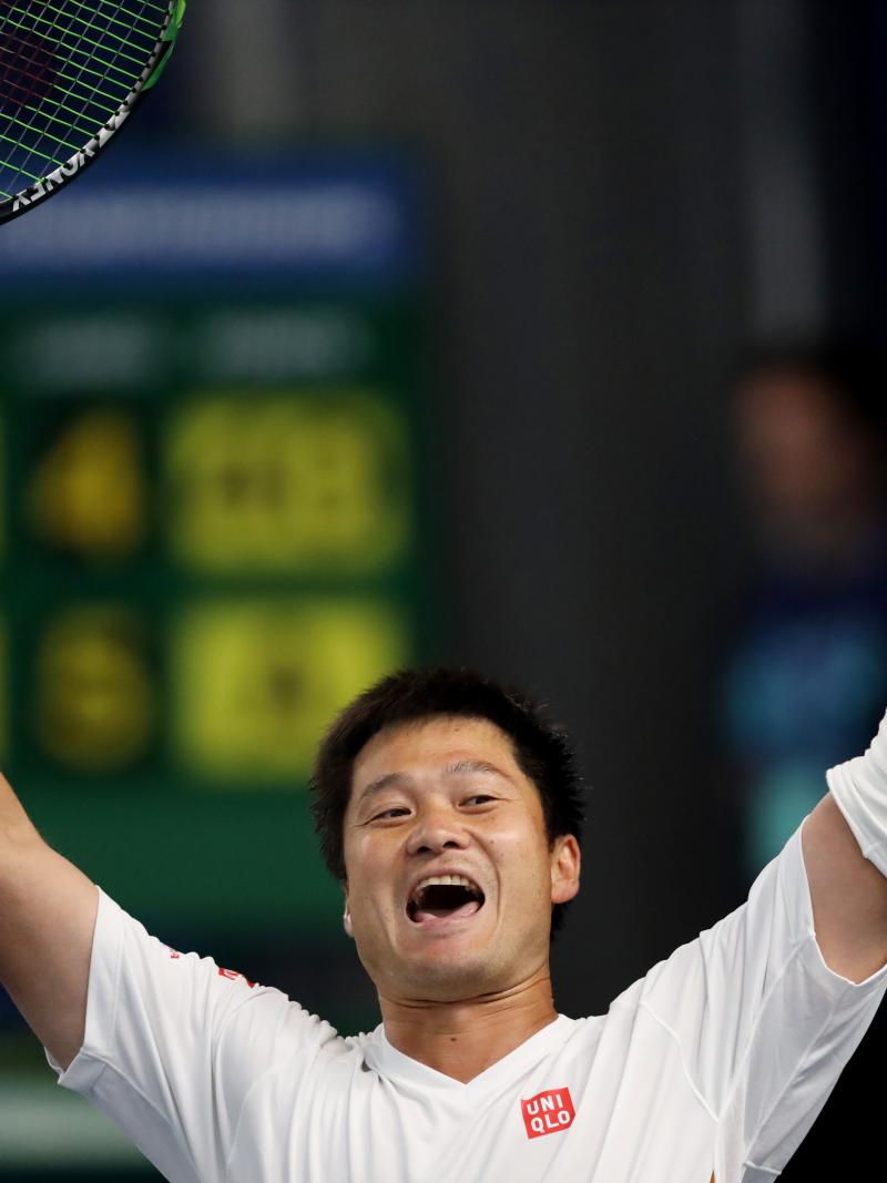 Japanese wheelchair tennis player Shingo Kunieda lifts his arms after winning the final