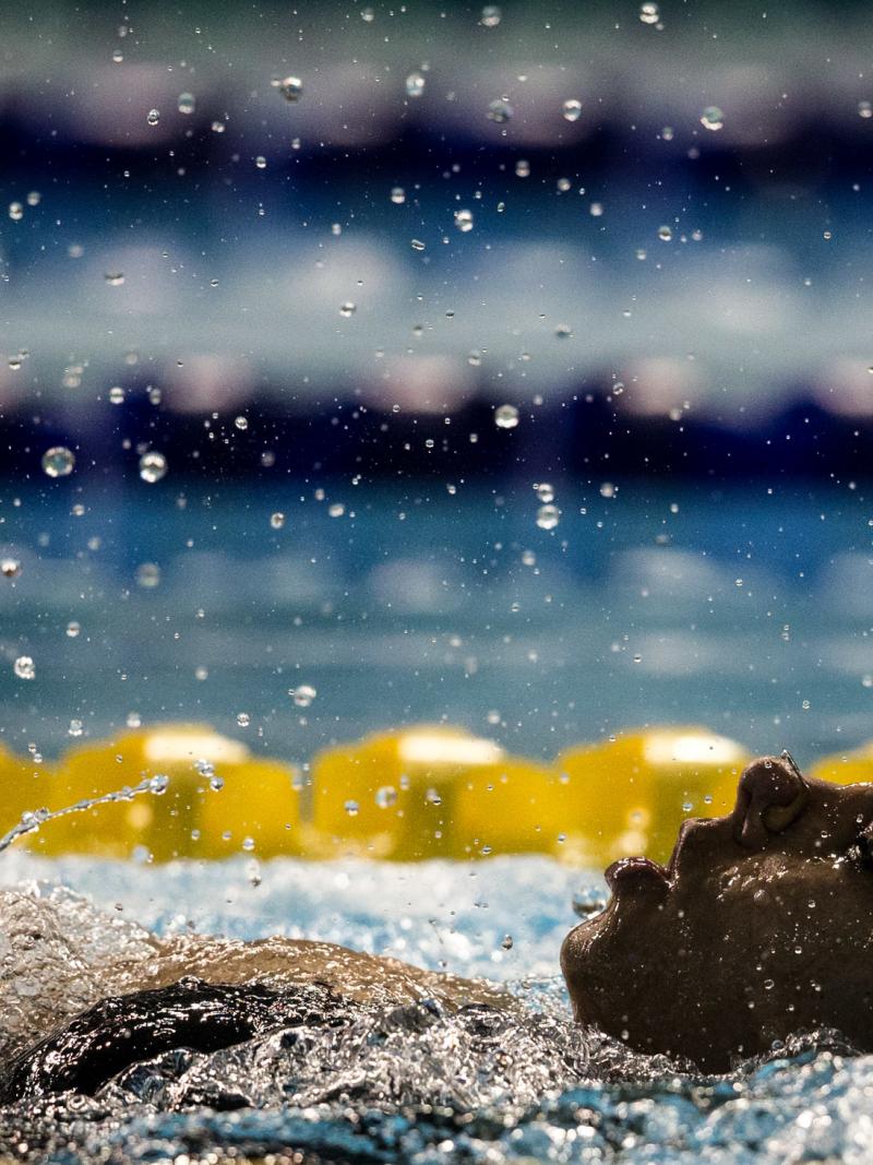 A woman swimming backstroke