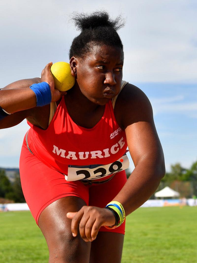 Teenage Mauritian female athlete prepares to release shot put