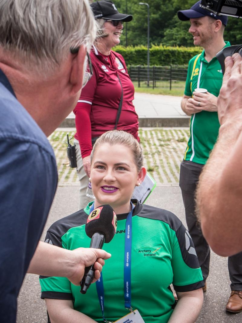 Woman in wheelchair being interviewed by media