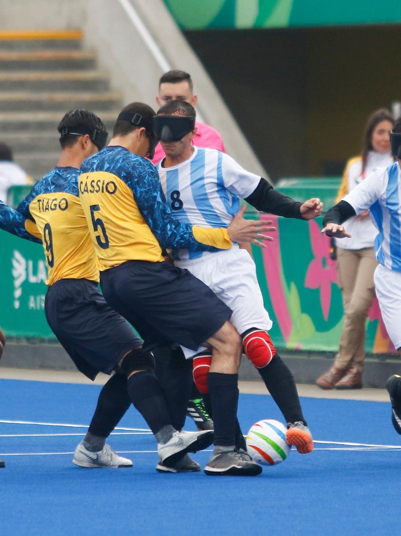 male blind footballers tackling for the ball