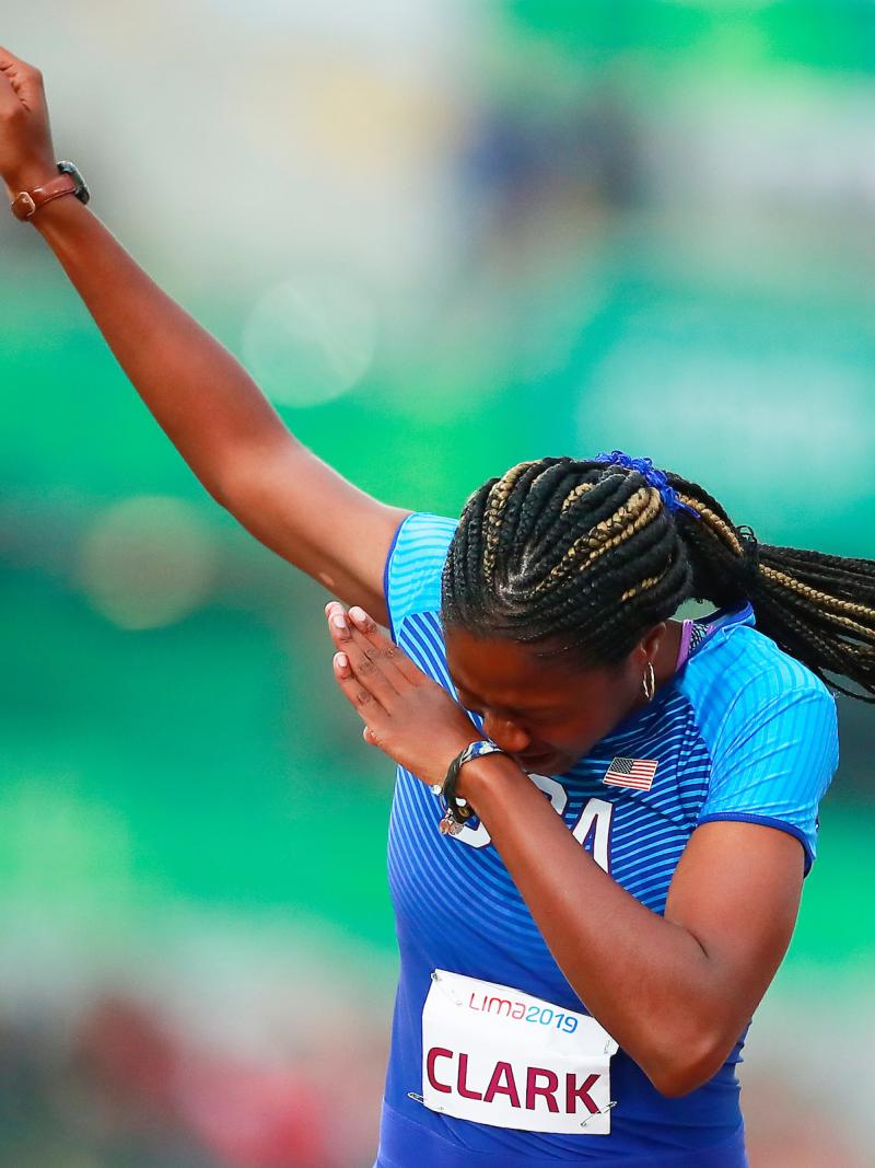 a female Para athlete celebrates on the finish line