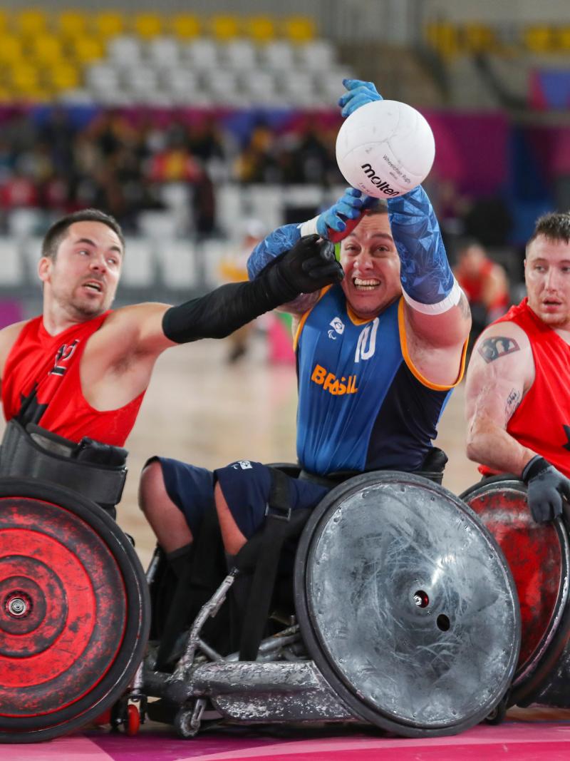 male wheelchair rugby players fight for the ball