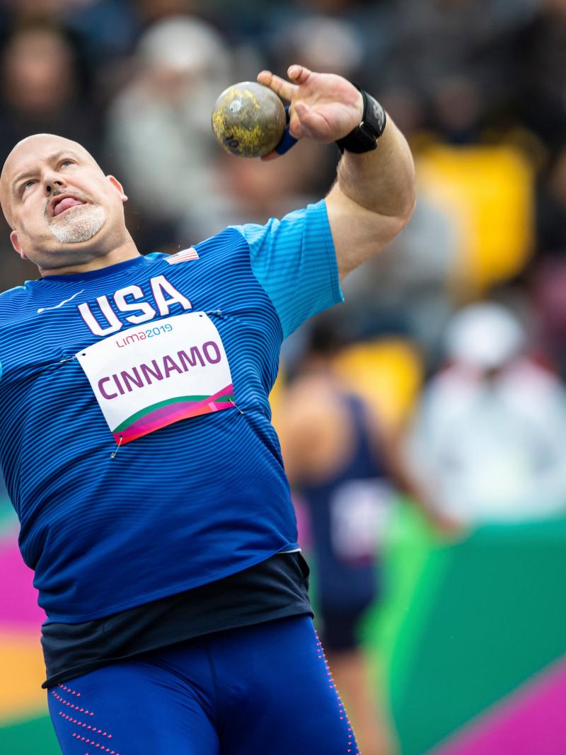 a male Para athlete throws a shot put