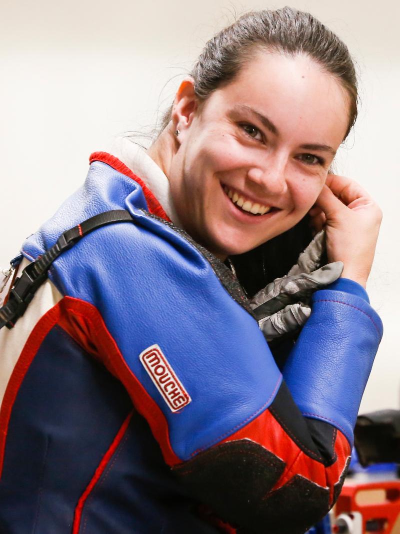 female Para shooter smiles at the camera