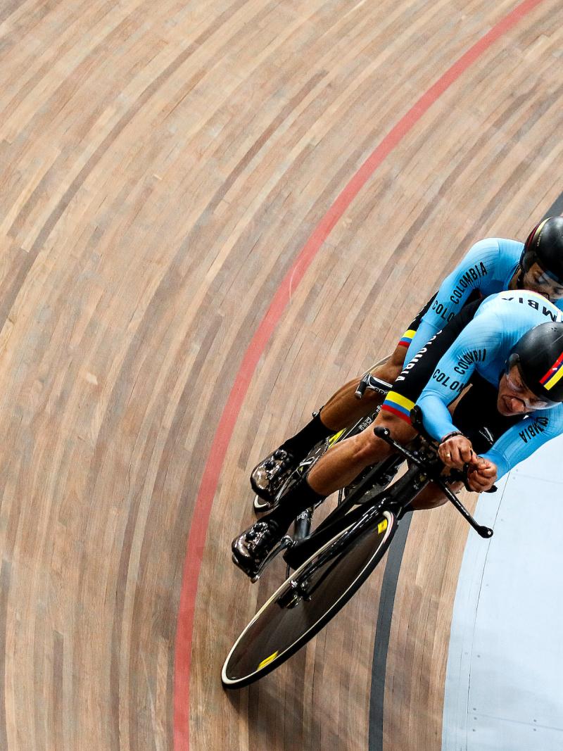 a male Para cycling tandem goes round a corner on the track