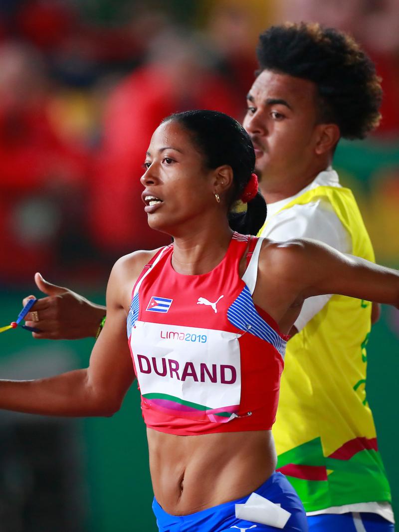 a female vision impaired runner and her guide running on the track