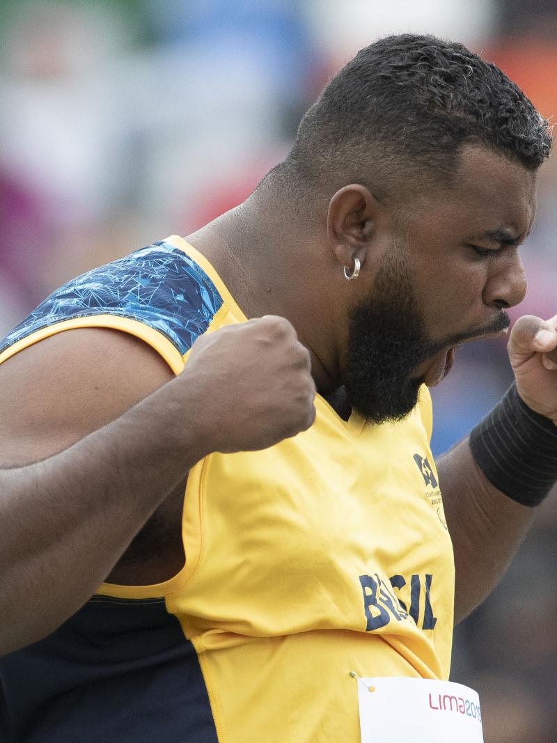 a male Para athlete screams in celebration with his fists clenched