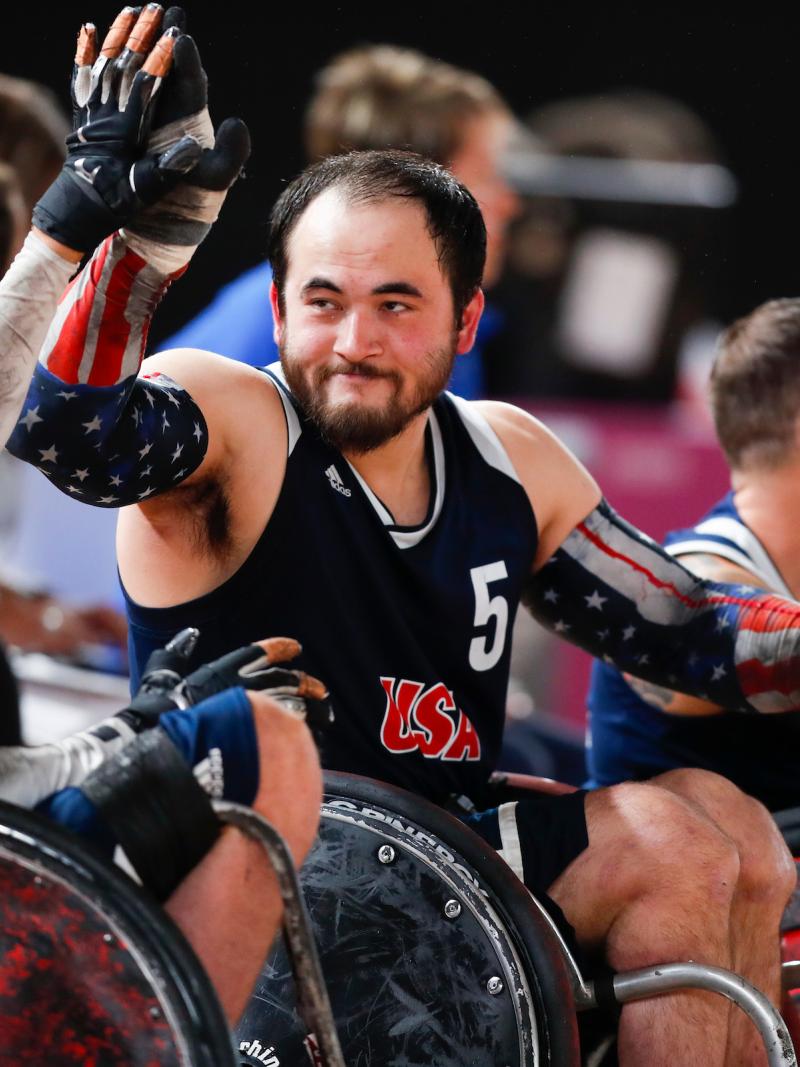male wheelchair rugby players high-five