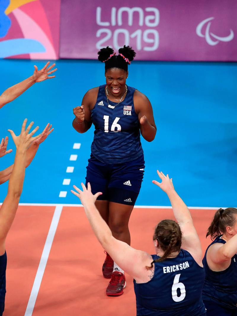 female sitting volleyball players celebrating on the court
