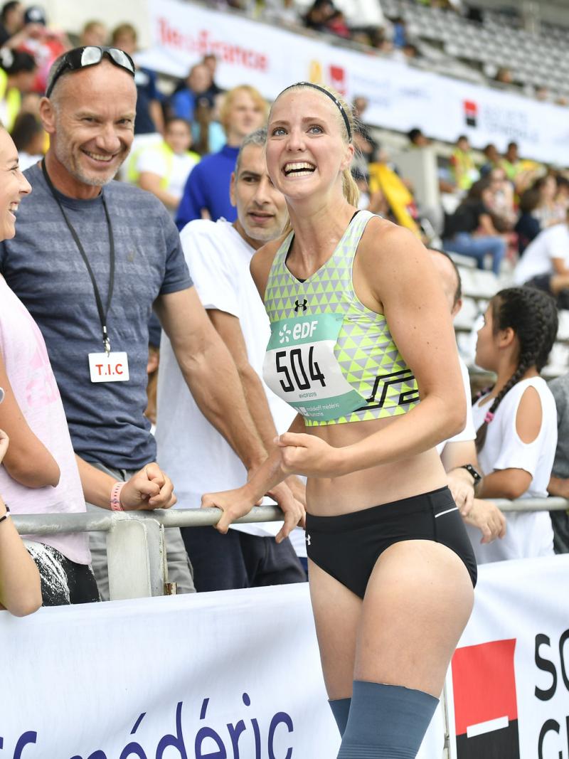 a female Para athlete celebrates with fans