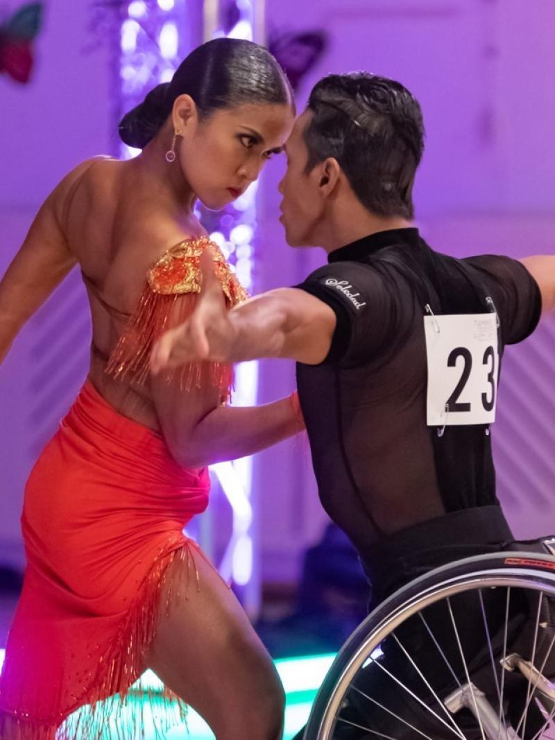 Female standing dancer dancers with male wheelchair dancer