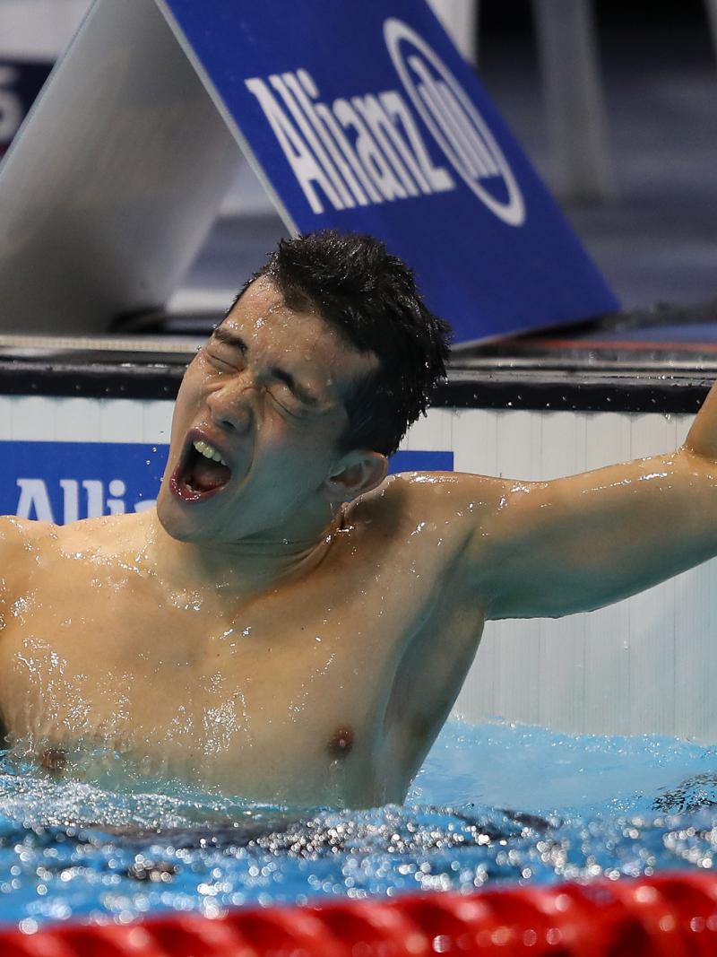 a male Para swimmer celebrates in the water