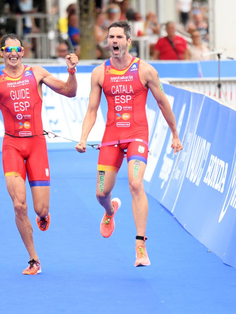 Vision impaired triathlon and his guide celebrate at the finish line