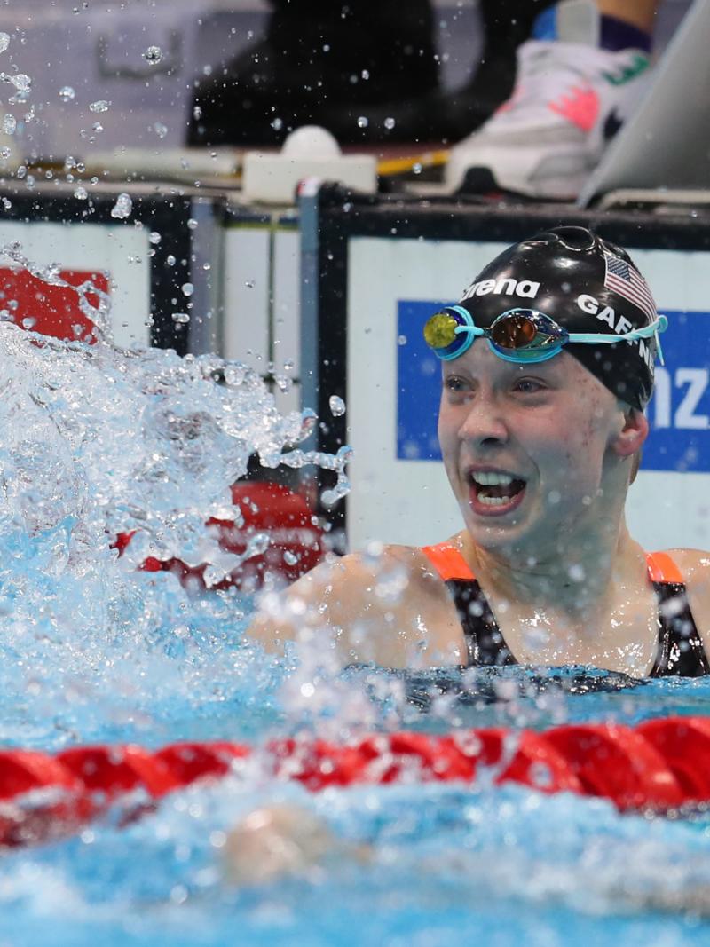 US female swimmer splashes water to celebrate