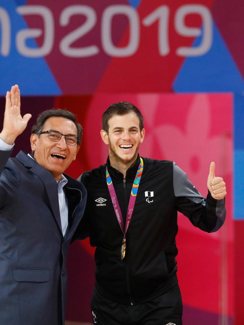 two men giving a thumbs up on the podium