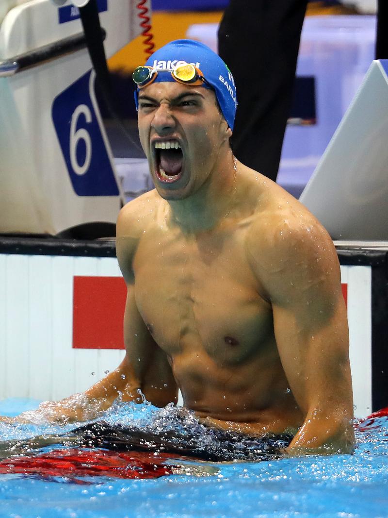 a male Para swimmer celebrates in the water