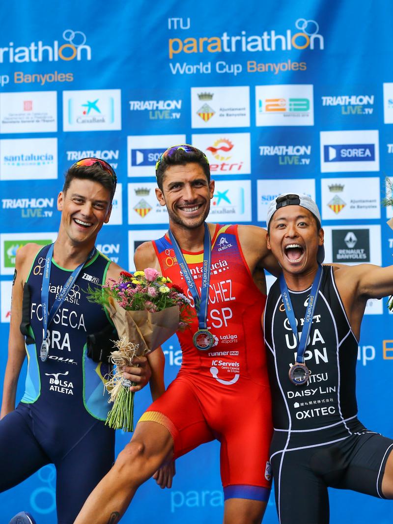 Three male Para triathletes have fun posing for a podium photo