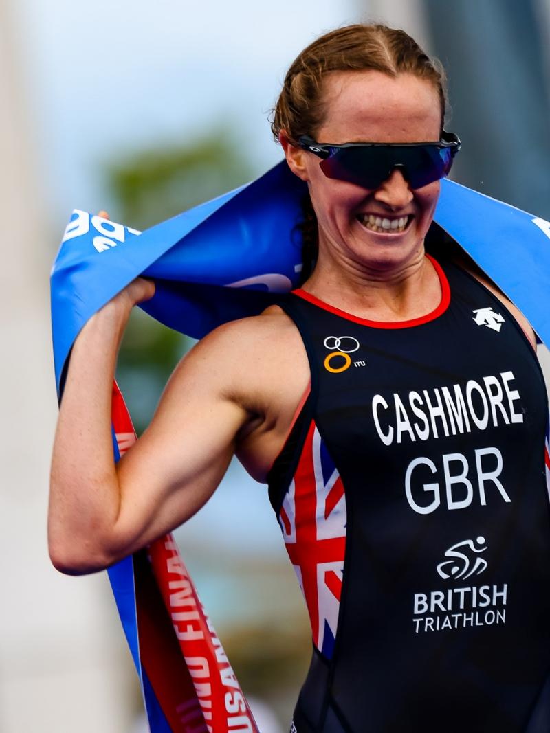 British triathlete with arm disability smile crossing the finish line tape