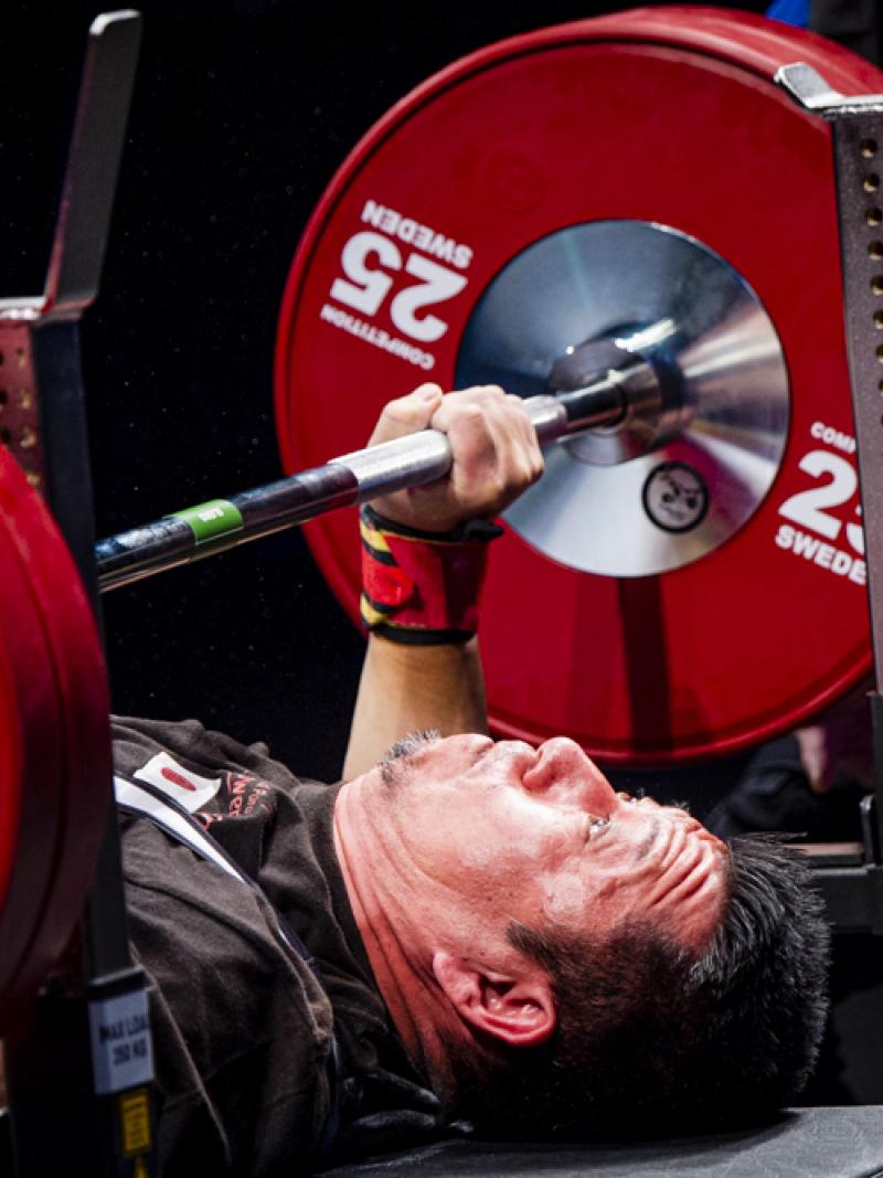 A male powerlifter preparing to lift the bar