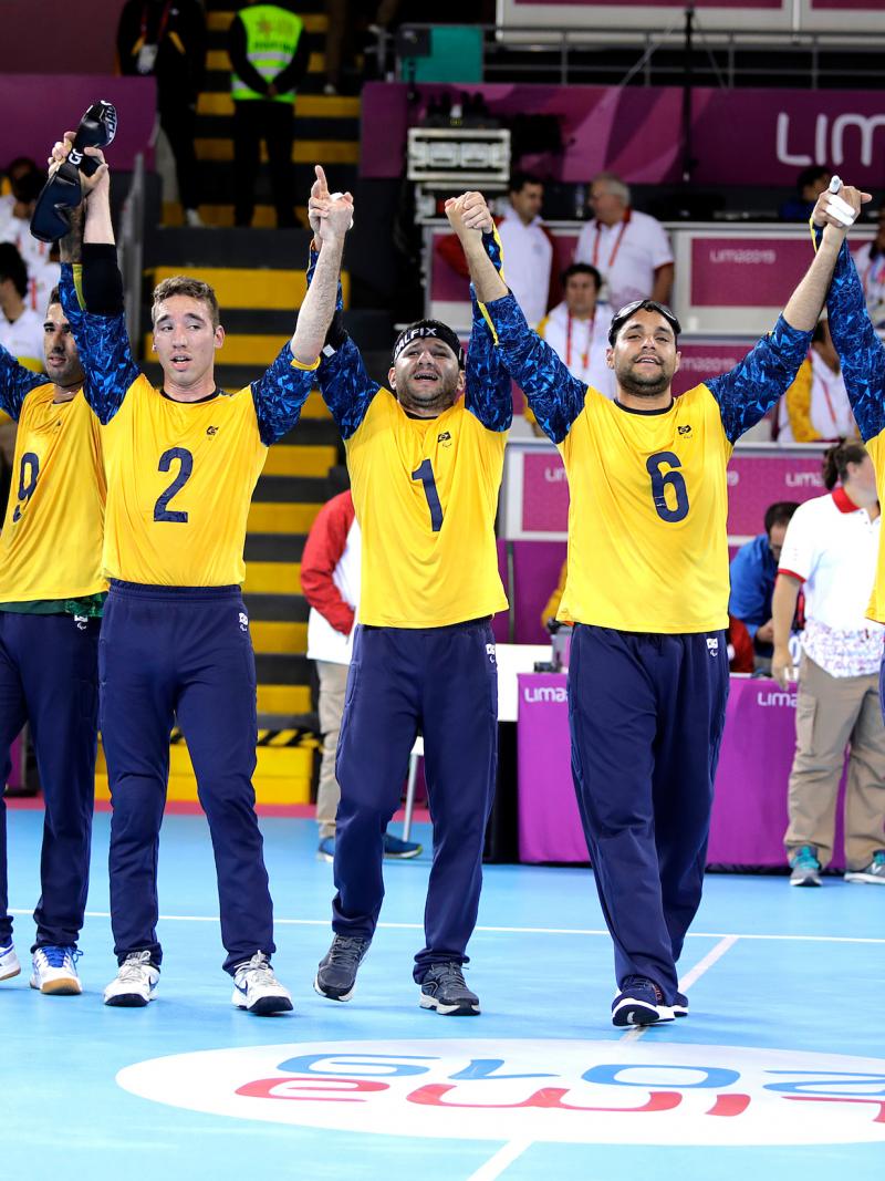 Brazilian goalball players lifting their arms to celebrate after winning the Lima 2019 competition