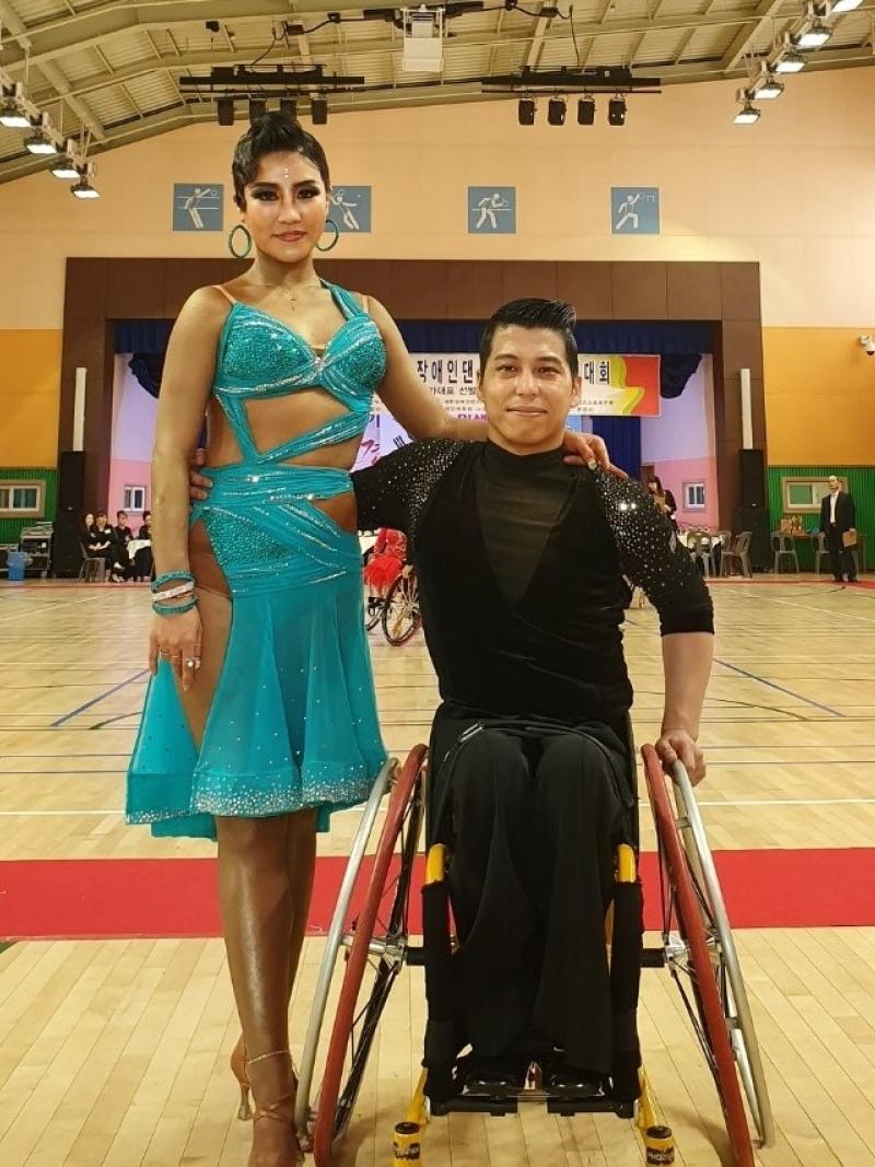 Male Korean wheelchair dancer poses with female standing partner