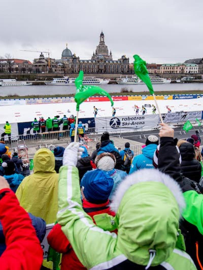 A group of fans watching a cross-country skiing competition in the centre of Dresden