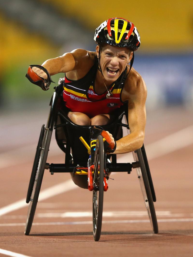 Marieke Vervoort celebrates as she crosses the finish line