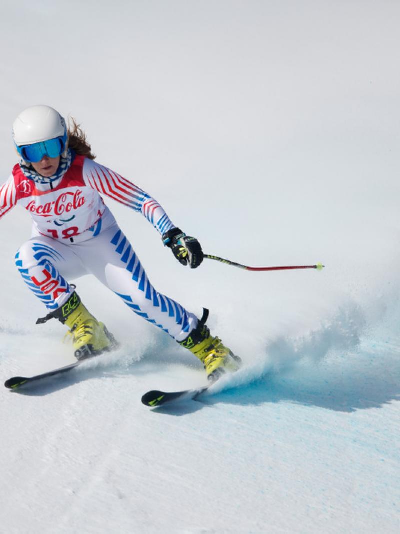 A female Para alpine skier competing on the snow