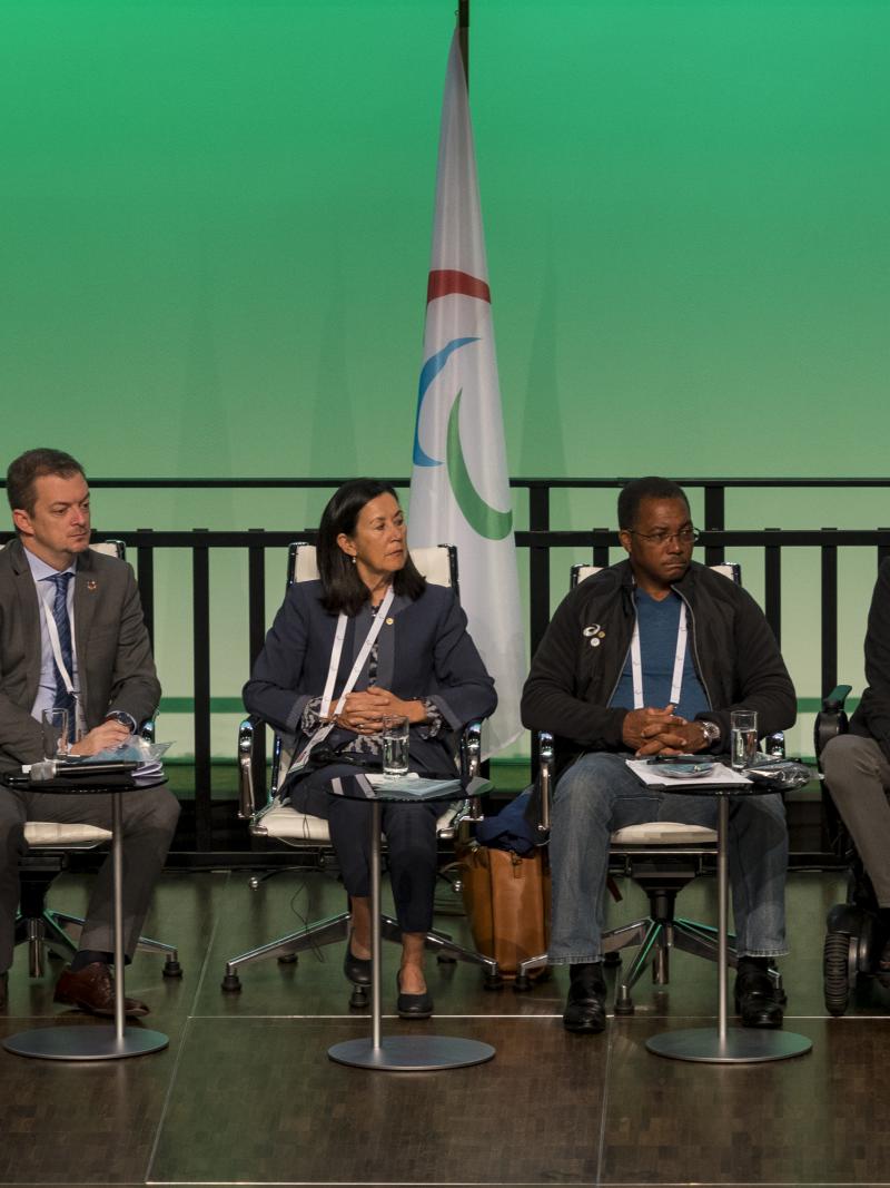 Five IPC governing board members sit and listen