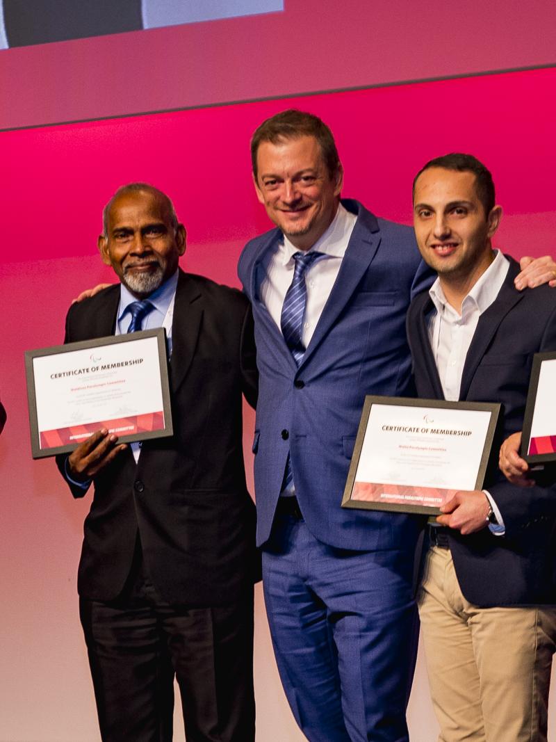 IPC President poses with three NPC presidents holding certificates of membership