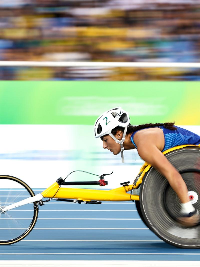 A female wheelchair racer on a blue track