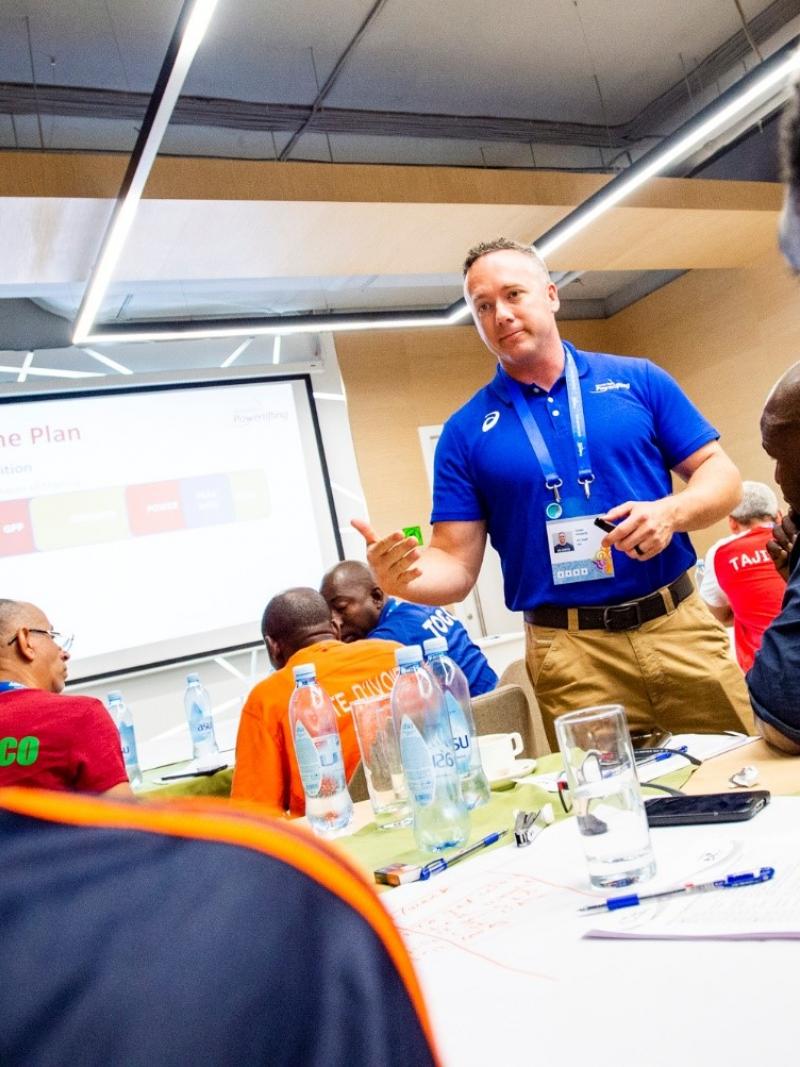 Powerlifting mentor speaks during an educational course