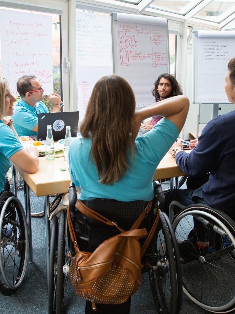 Five Proud Paralympian Educators work in group during a course in Bonn